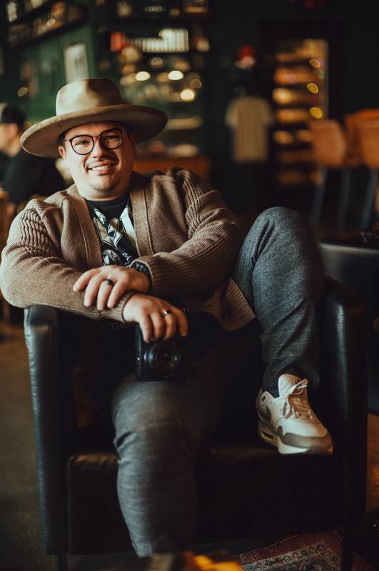 Keegan Sullivan, founder of Sullivan Creative Co., sitting in a leather chair