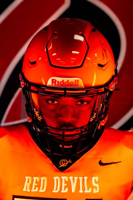 Football player in a red helmet under dramatic light