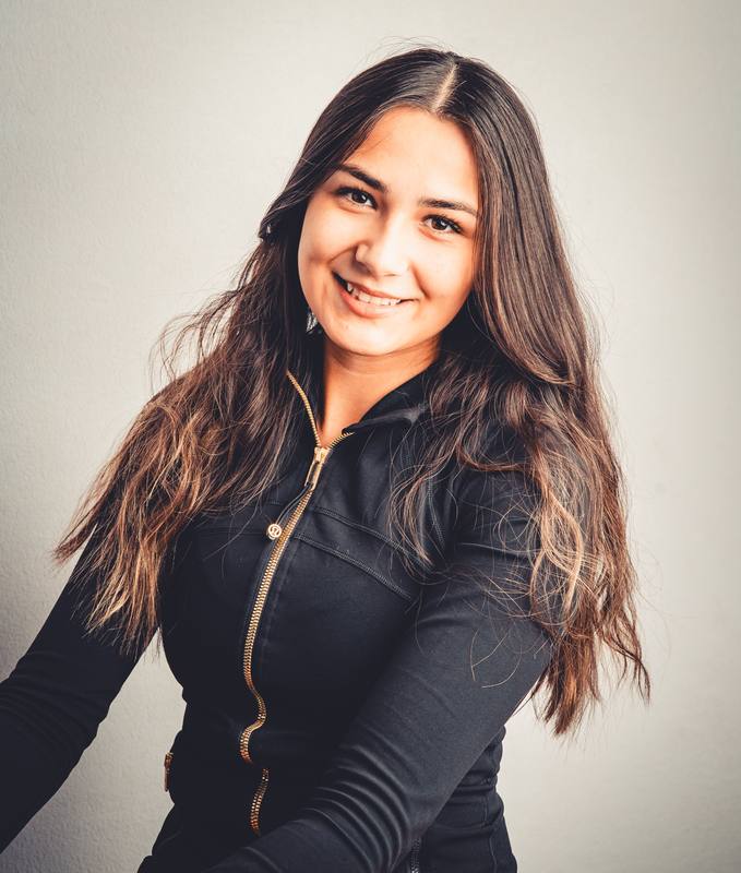 Smiling portrait of a woman with long dark hair