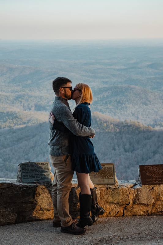 Couple kissing at a mountain overlook