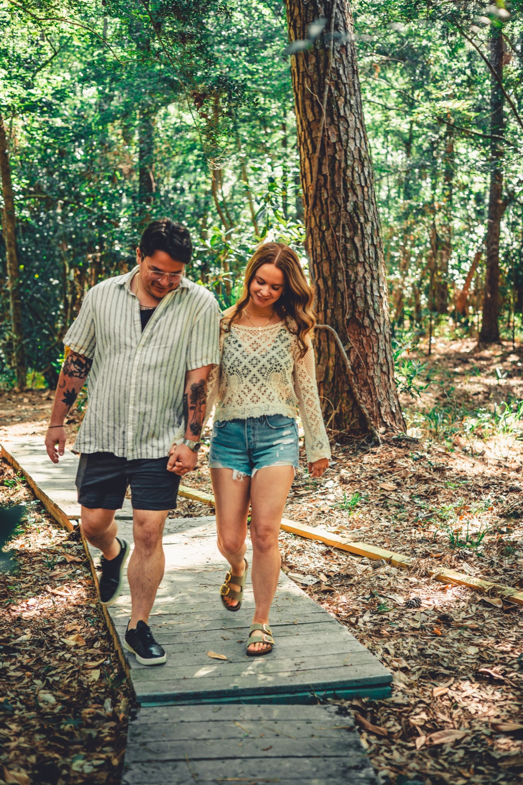 Keegan Sullivan and his wife walking through the woods, by Sullivan Creative Co., Greenville SC